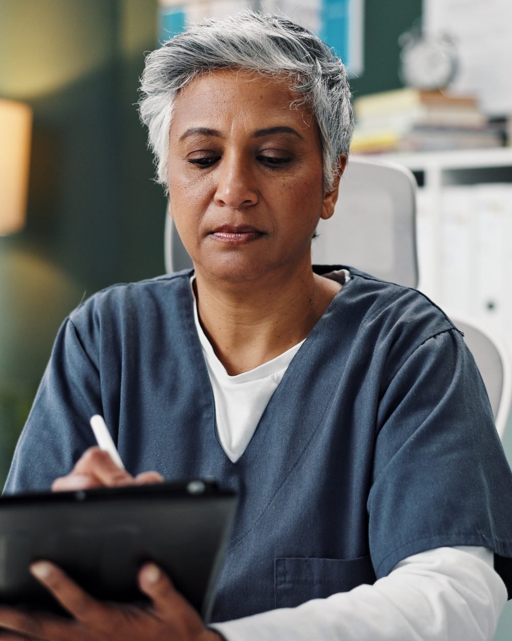 Healthcare provider reviewing notes on a tablet